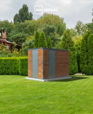 Small modern shed with blue-gray siding and orange doors in a well-kept green garden with hedges and trees behind it.